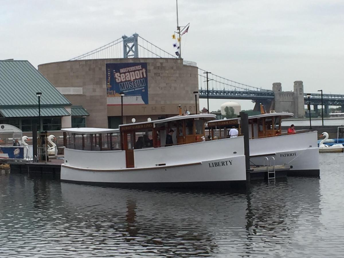 Patriot Fireworks Cruise Image 1 a boat is docked next to a body of water